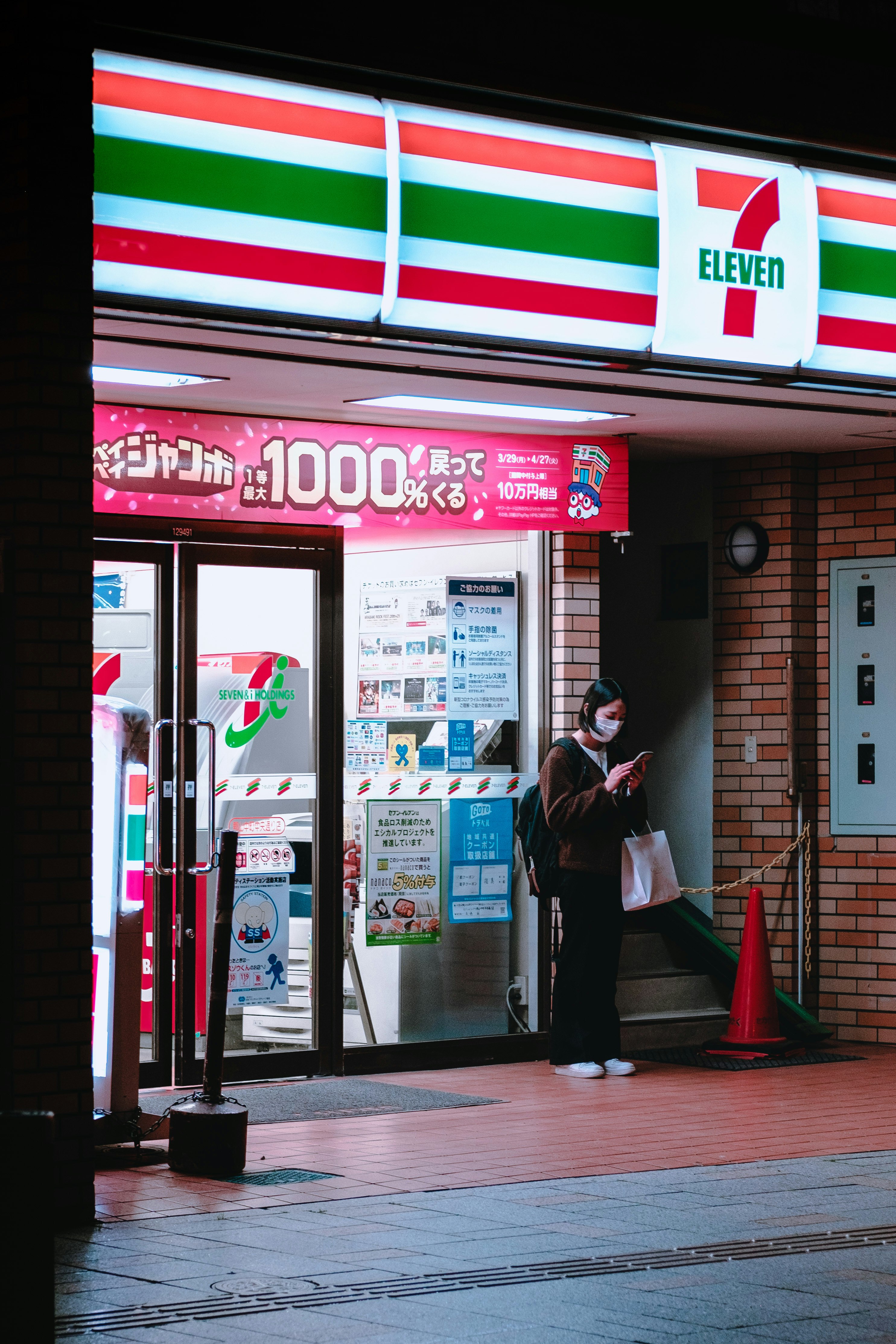 man in black jacket standing near glass door